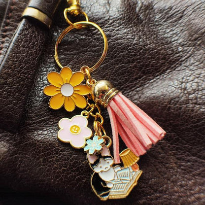 détail Porte-Clé Chat Noir et Blanc avec Lampe et Fleurs pompon